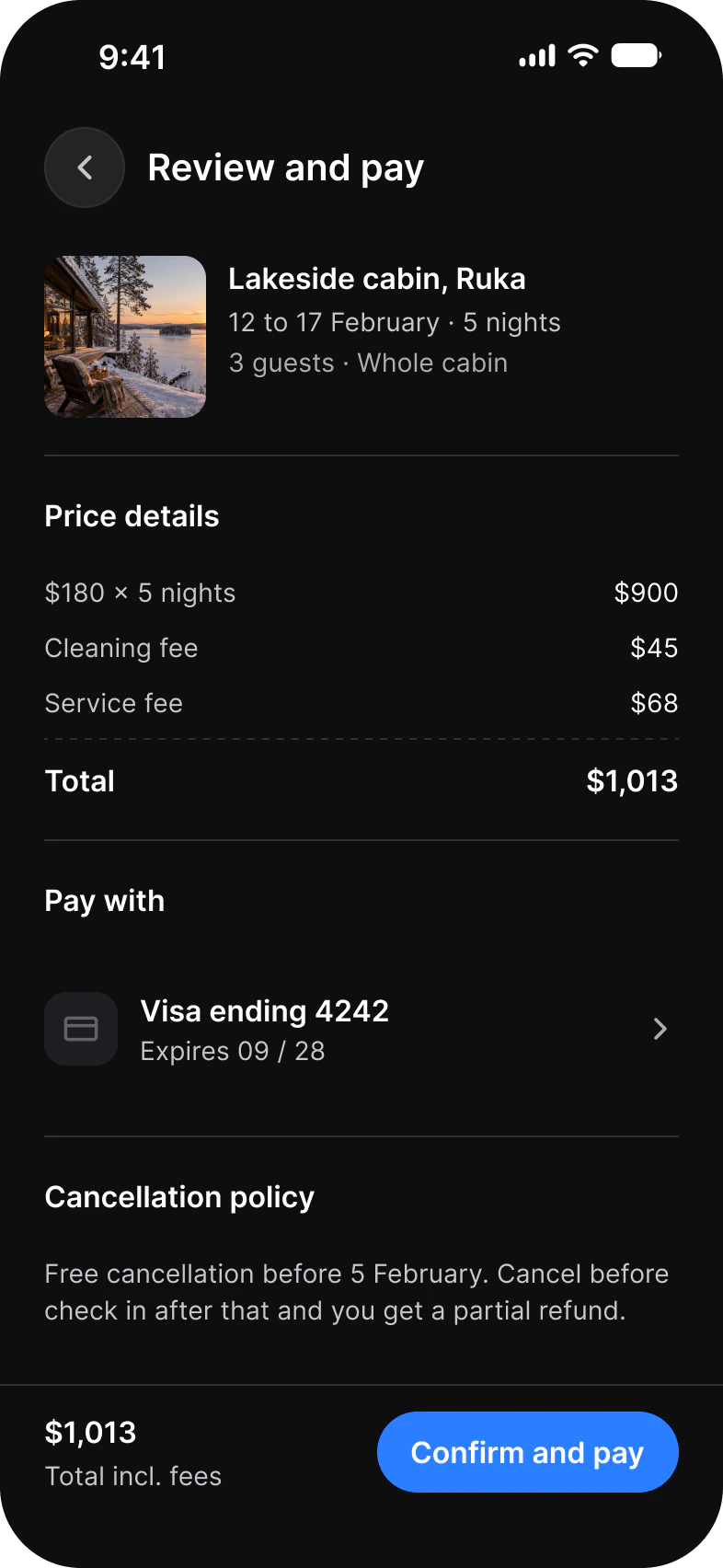 Review and pay screen in dark mode: a lakeside cabin in Ruka, price details, a Visa card and Confirm and pay