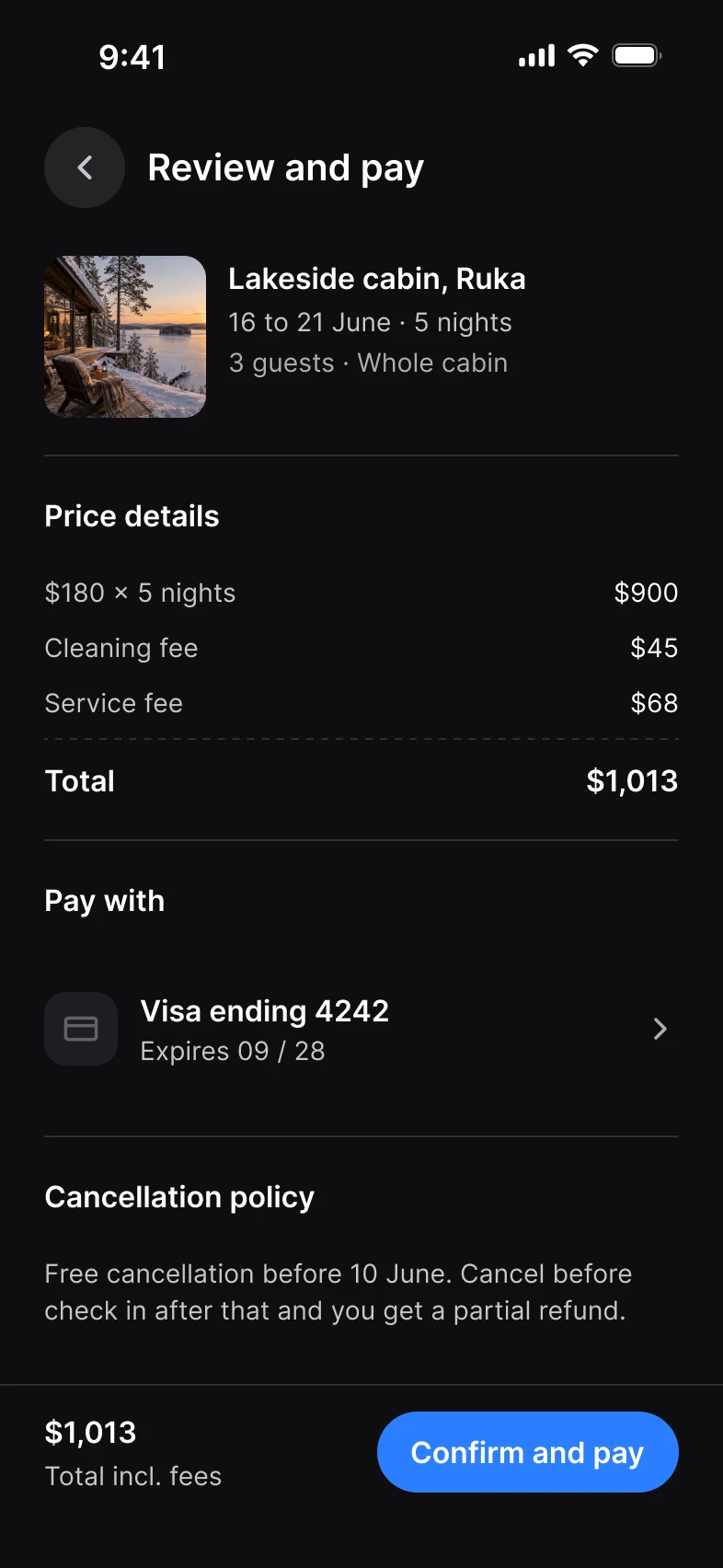 Review and pay screen in dark mode: a lakeside cabin in Ruka, price details, a Visa card and Confirm and pay